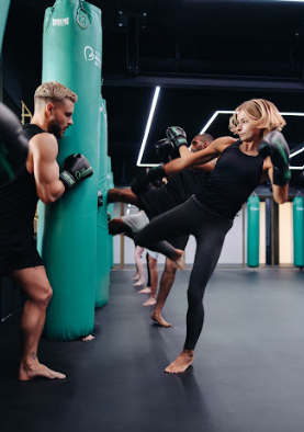 Woman kicking boxing bag