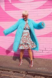 pink background blue coat